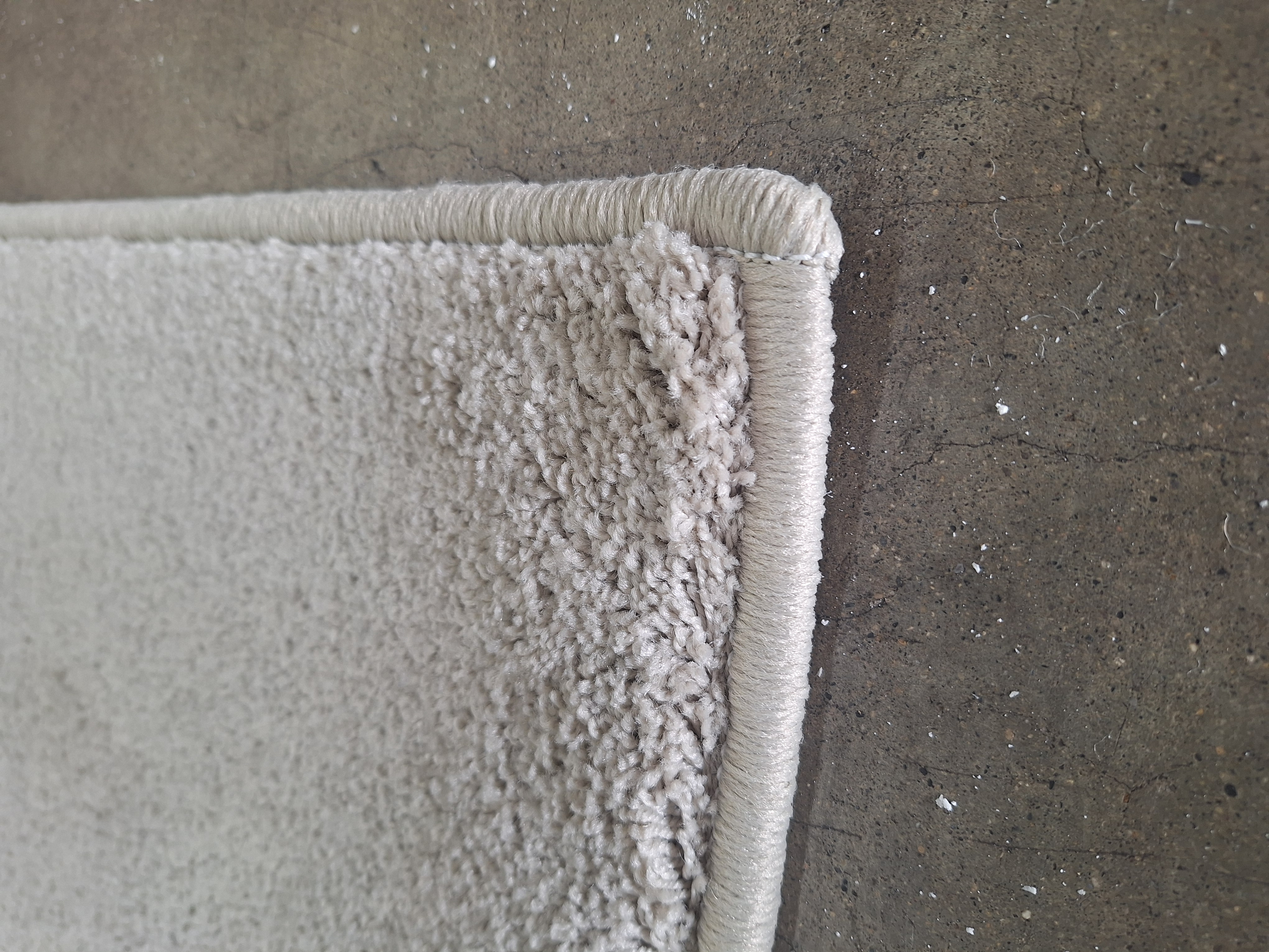 Custom plush gray area rug with professional edge surging by Brandon Doty
